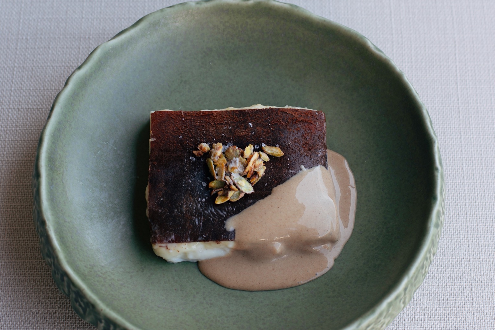 Shyra Restaurant - chestnut kazandibi with a caramelised dark base served on a green ceramic plate