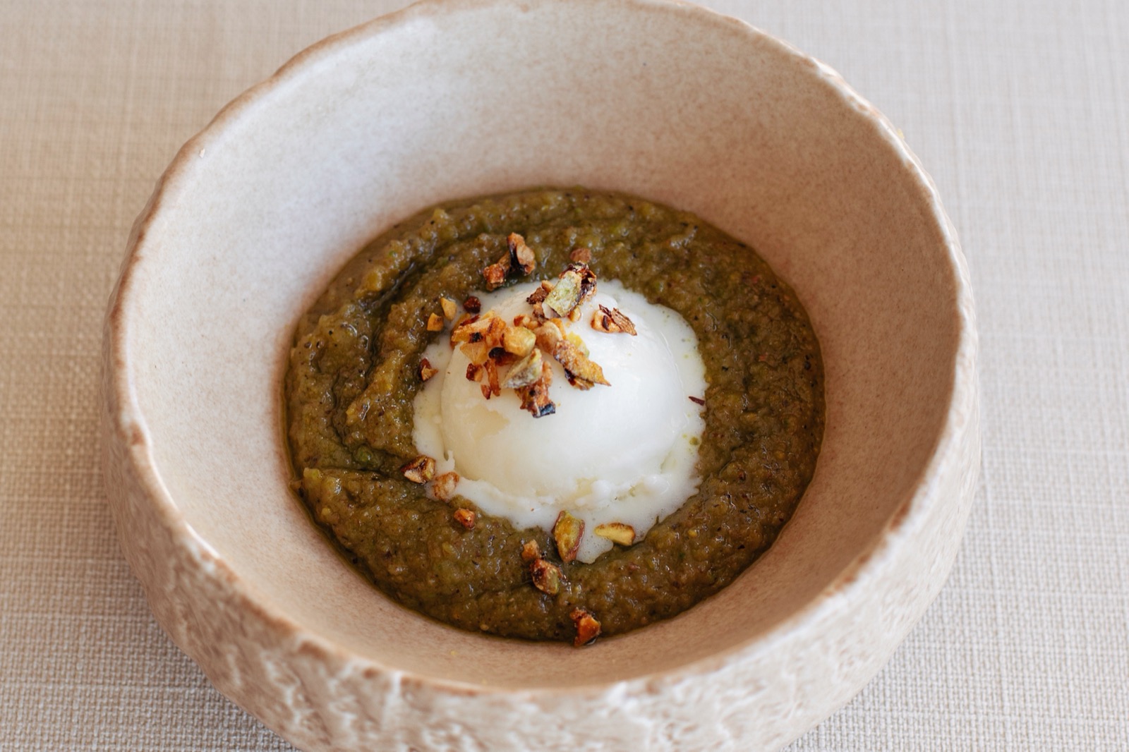 Shyra Restaurant - levzine, an Ottoman almond and pistachio dessert served with cream in a stone bowl